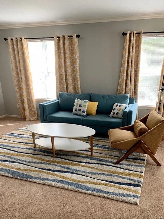 a living room with a blue couch and a coffee table
