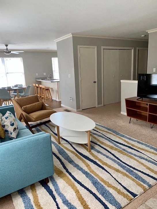 a living room with a blue couch and a coffee table