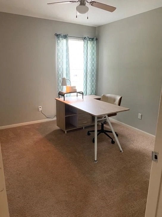 an empty room with a desk and a window