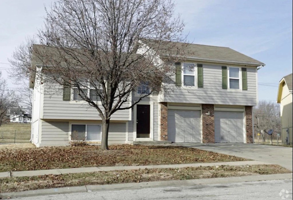 a house with a tree in the front yard