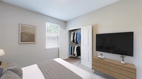 A bedroom with a bed, a TV, and a wardrobe.