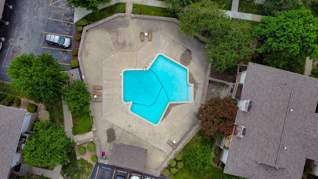 arial view of a swimming pool in the middle of a house