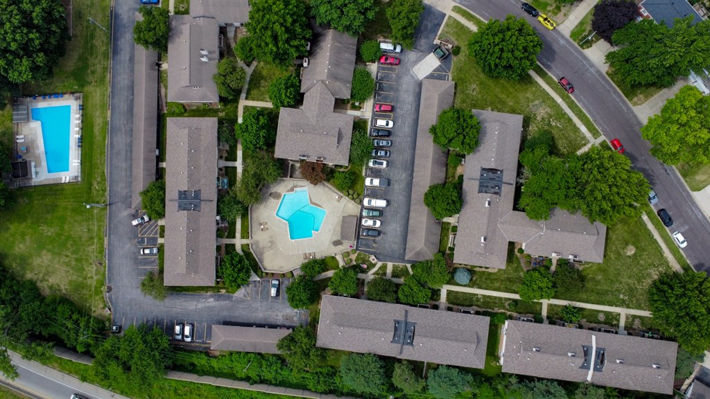 arial view of a neighborhood with houses and a swimming pool