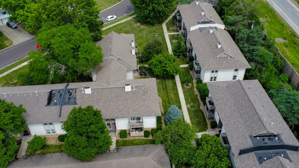 a aerial view of a neighborhood of houses with multiple roofs