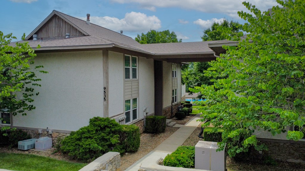 a white house with a sidewalk in front of it