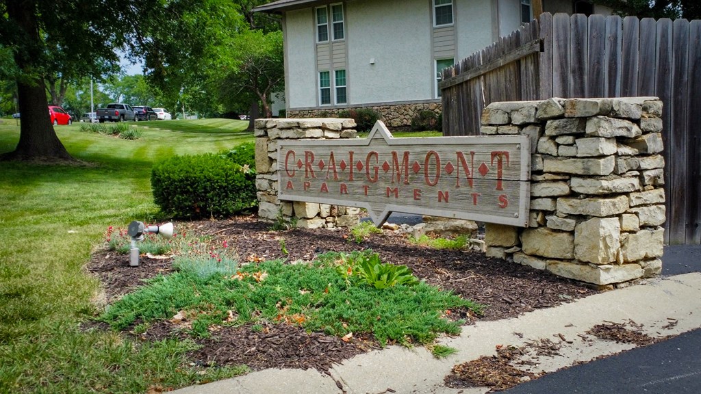 a sign in front of a house that reads