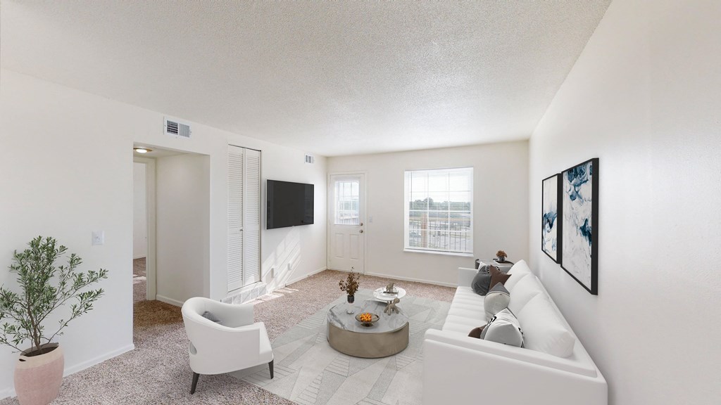 a living room with a white couch and a tv