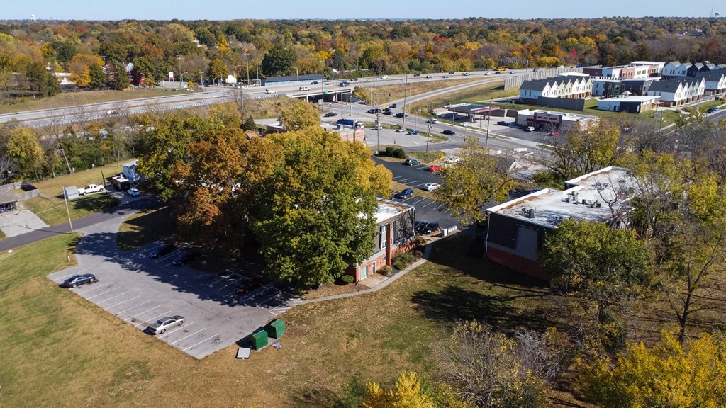 an aerial view of a city with a highway in the background