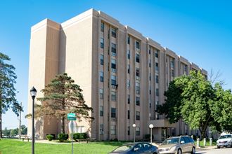 a large building with cars parked in front of it