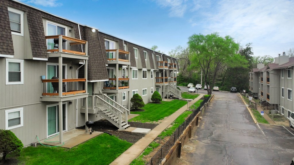 a view of a row of apartment buildings on a city street