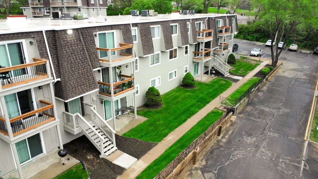 an aerial view of an apartment building with green grass