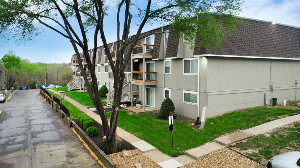 the view of an apartment building from the street