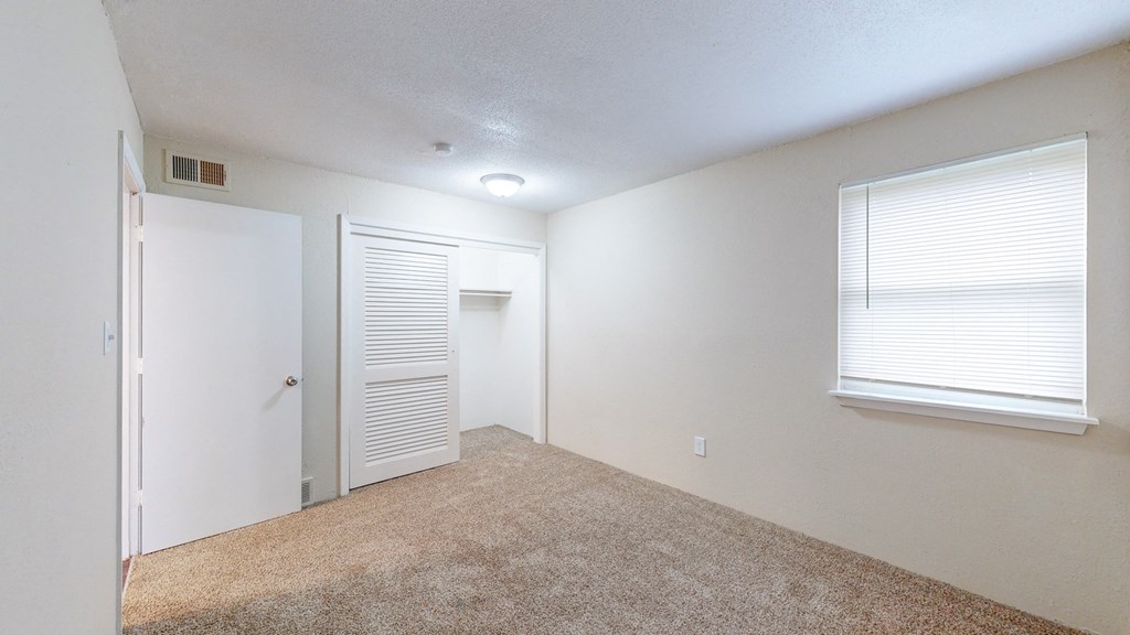 an empty room with a door and a window