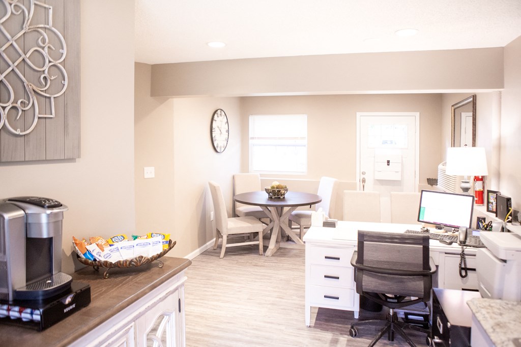 a kitchen and living room with a desk and a computer