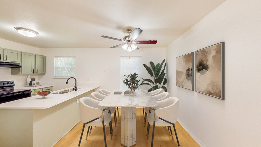a dining room with a white table and chairs