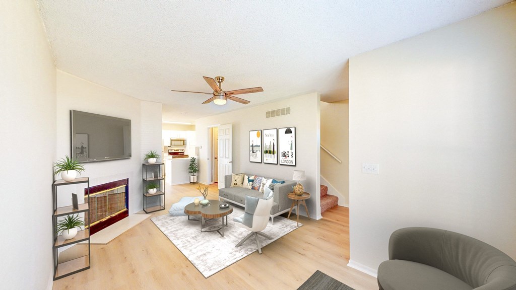 a living room with a couch and a ceiling fan