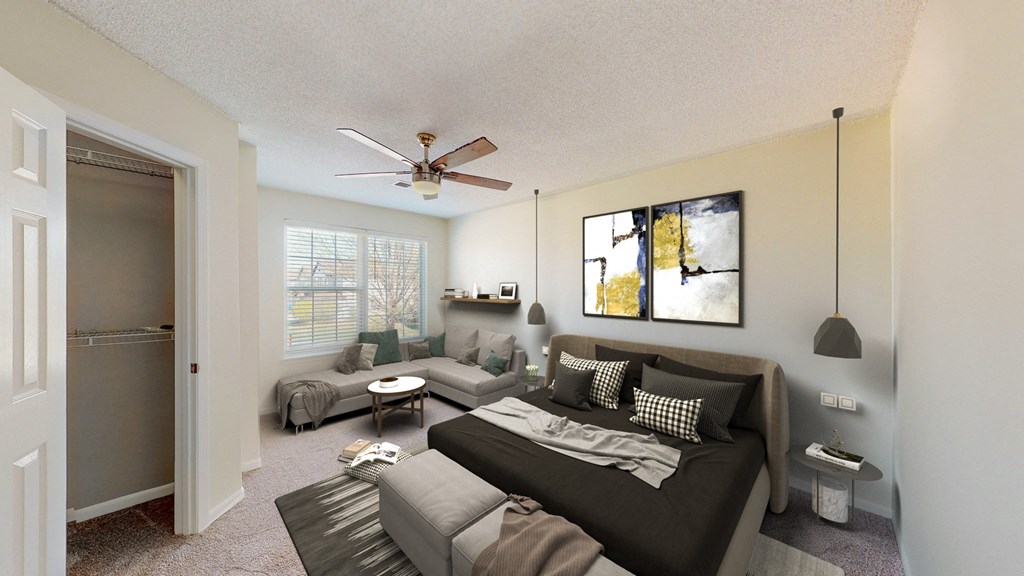 a living room with a couch and a ceiling fan