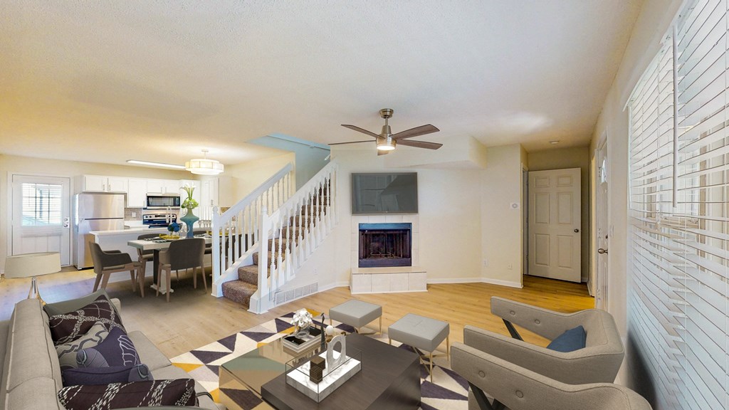 a living room with a fireplace and a staircase