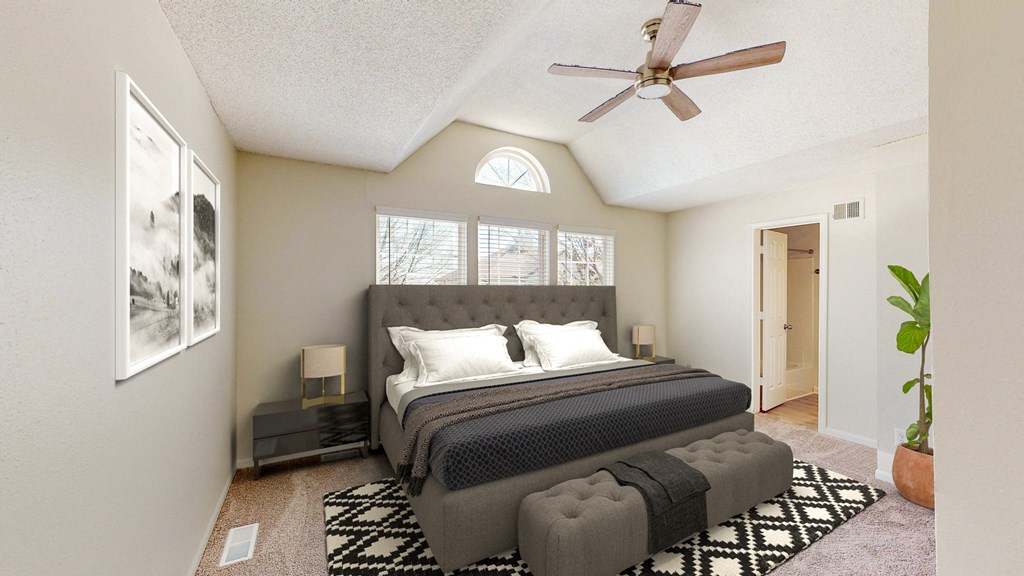 a bedroom with a bed and a ceiling fan