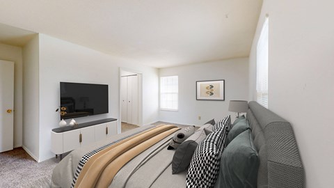 a bedroom with a large bed and a tv in the corner