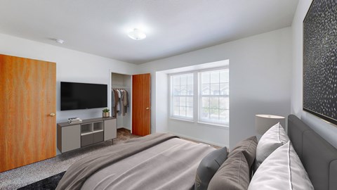 A bedroom with a large bed and a television.