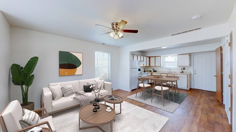 A living room with a white couch and a wooden coffee table.