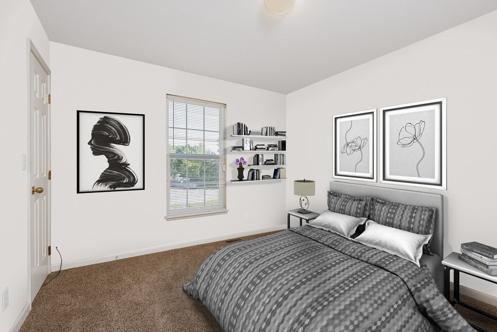 A bedroom with a bed, nightstand, and two framed artworks on the wall.