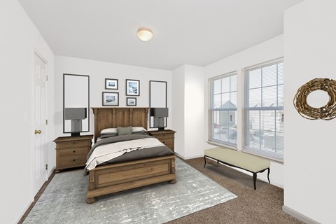 A bedroom with a bed, nightstands, and pictures on the wall.