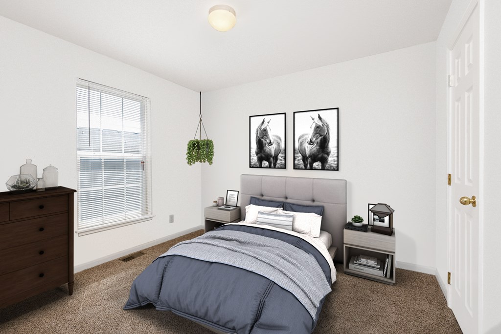 A bedroom with a bed, nightstand, and two framed pictures on the wall.