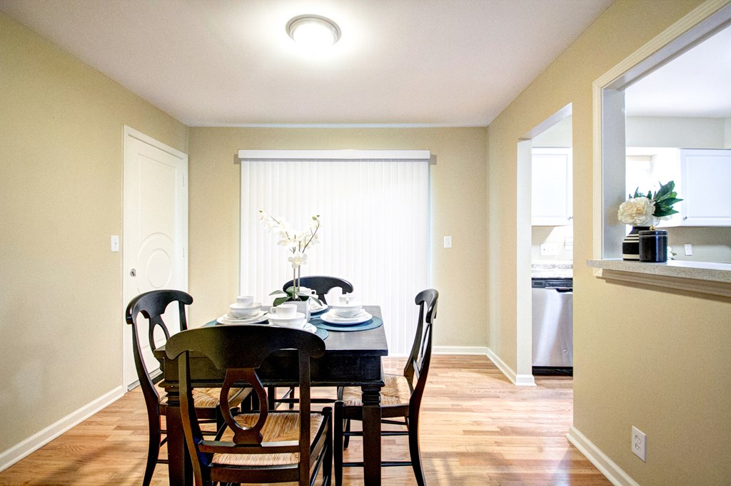 A dining room with a table set for two.