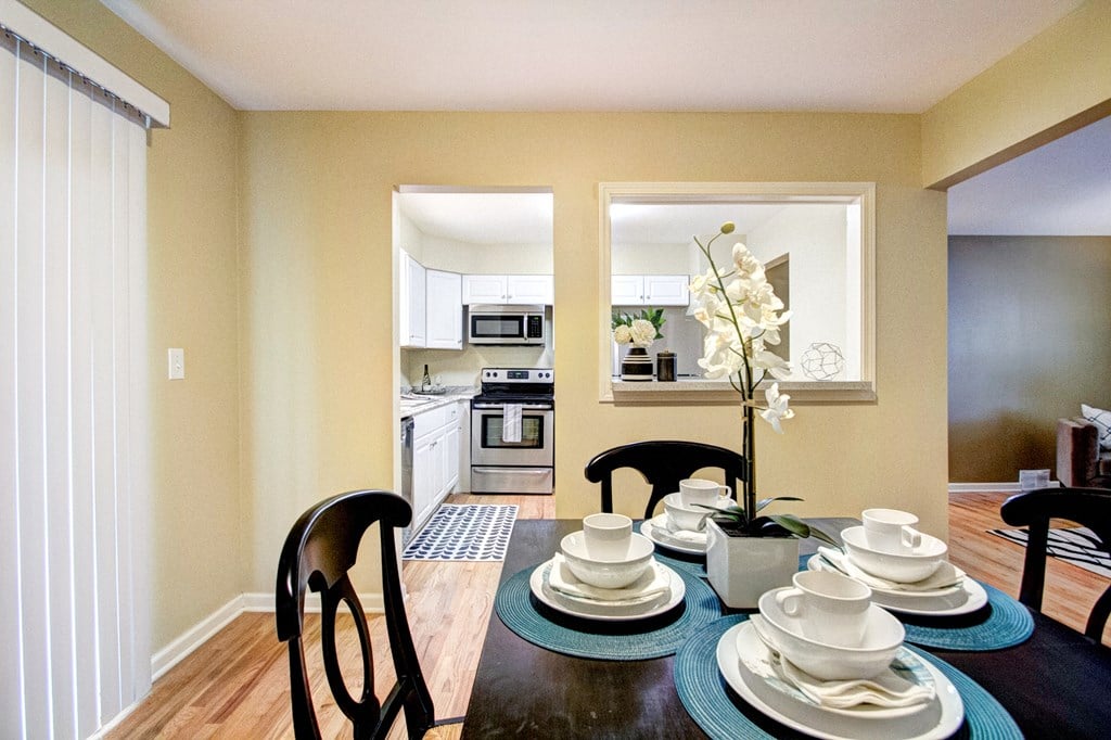 A dining room with a table set for two.