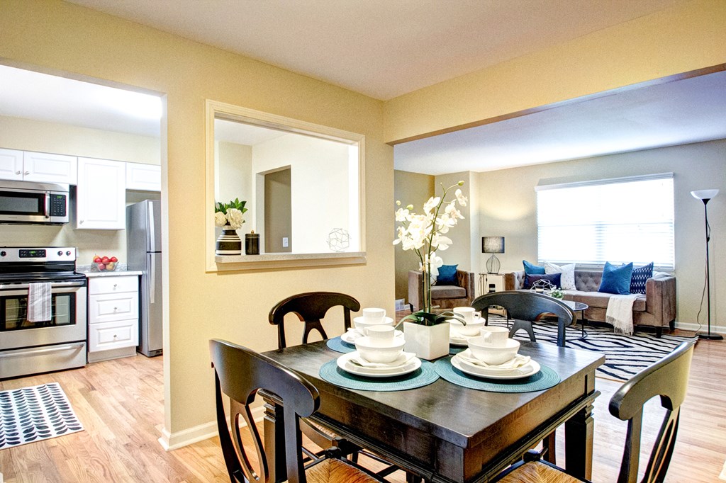 A dining room with a table set for two.