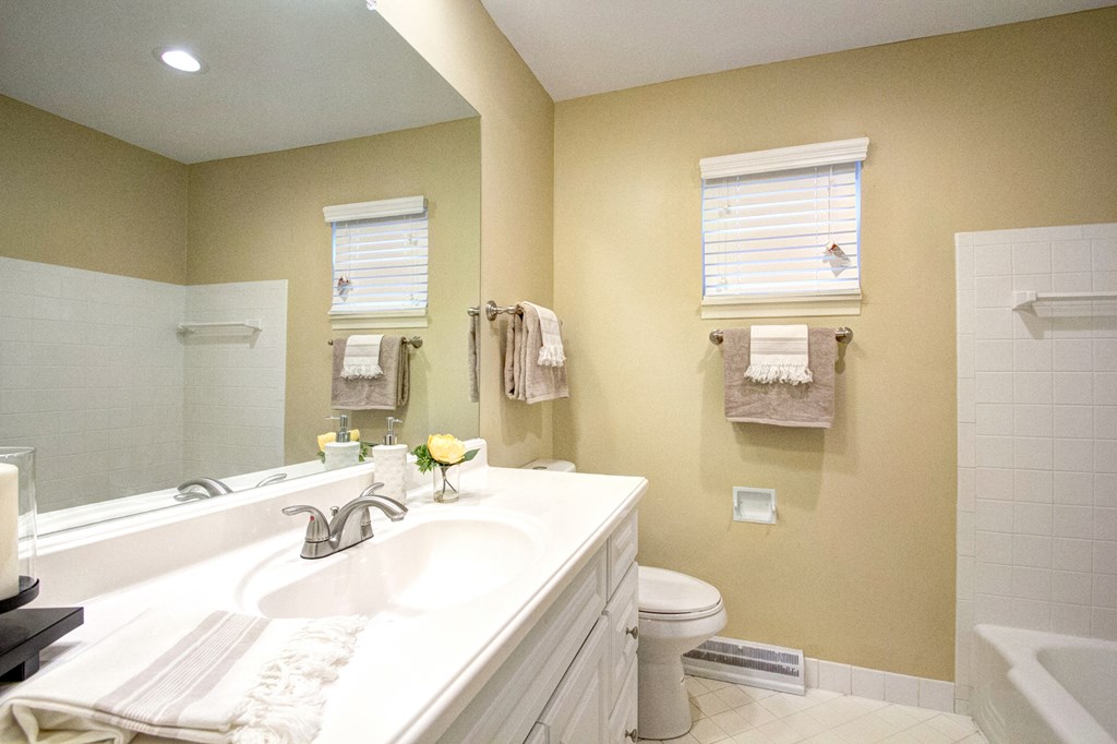 A bathroom with a white sink and a toilet.