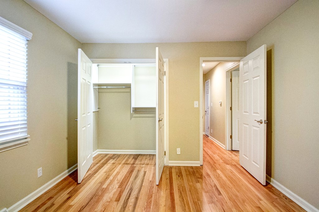 A room with a wooden floor and a white door.
