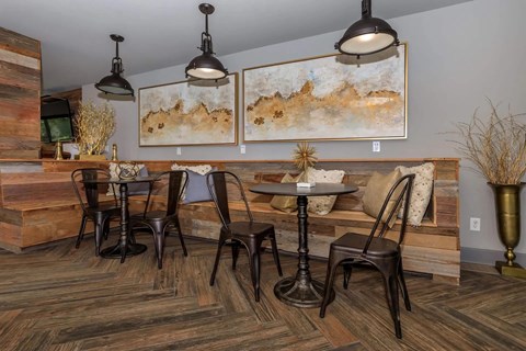 A dining room with a wooden table and chairs.