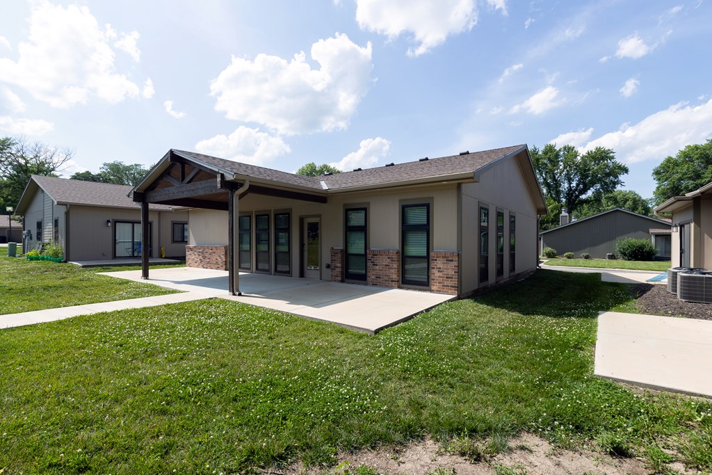 A modern house with a large front yard.