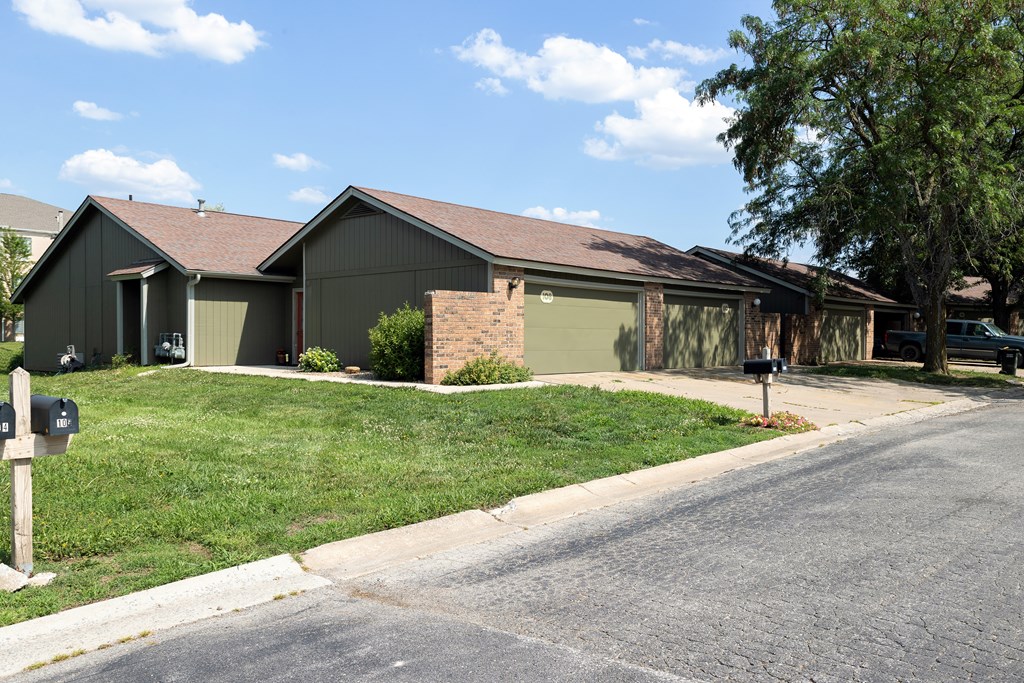 A house with a grey roof and a green lawn.