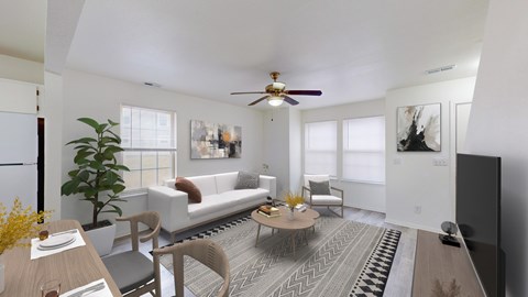 A living room with a white couch, a coffee table, and a ceiling fan.