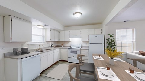 A modern kitchen with white appliances and a dining table set for two.