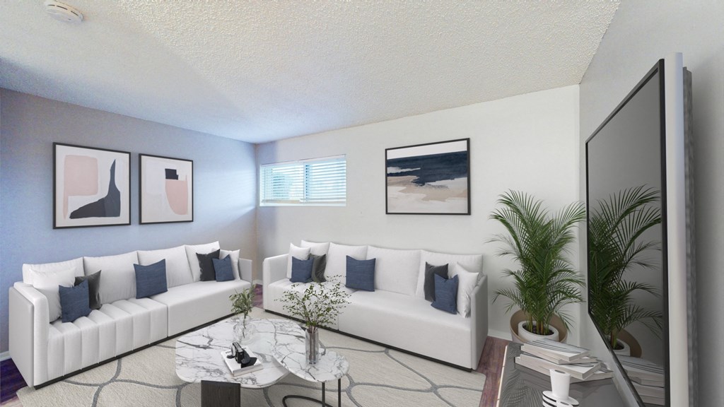 A living room with a white couch and a coffee table.