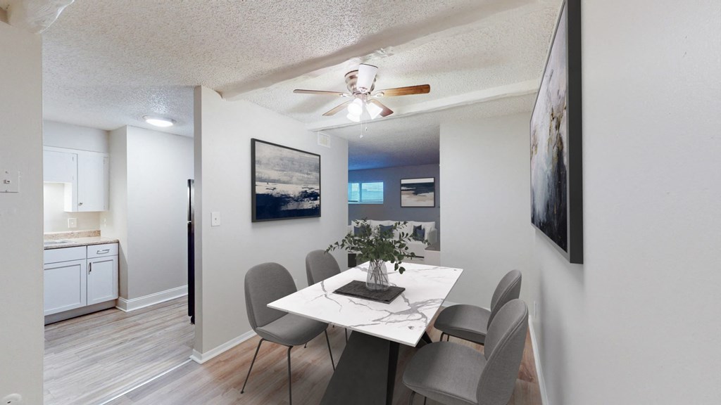 A dining room with a table and chairs.