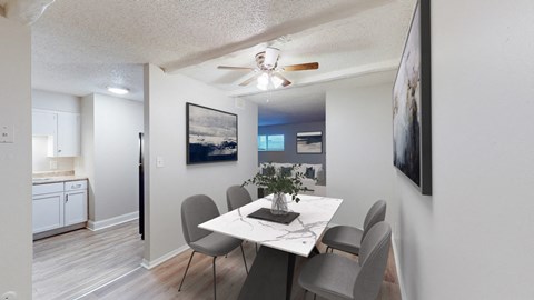 A dining room with a table and chairs.