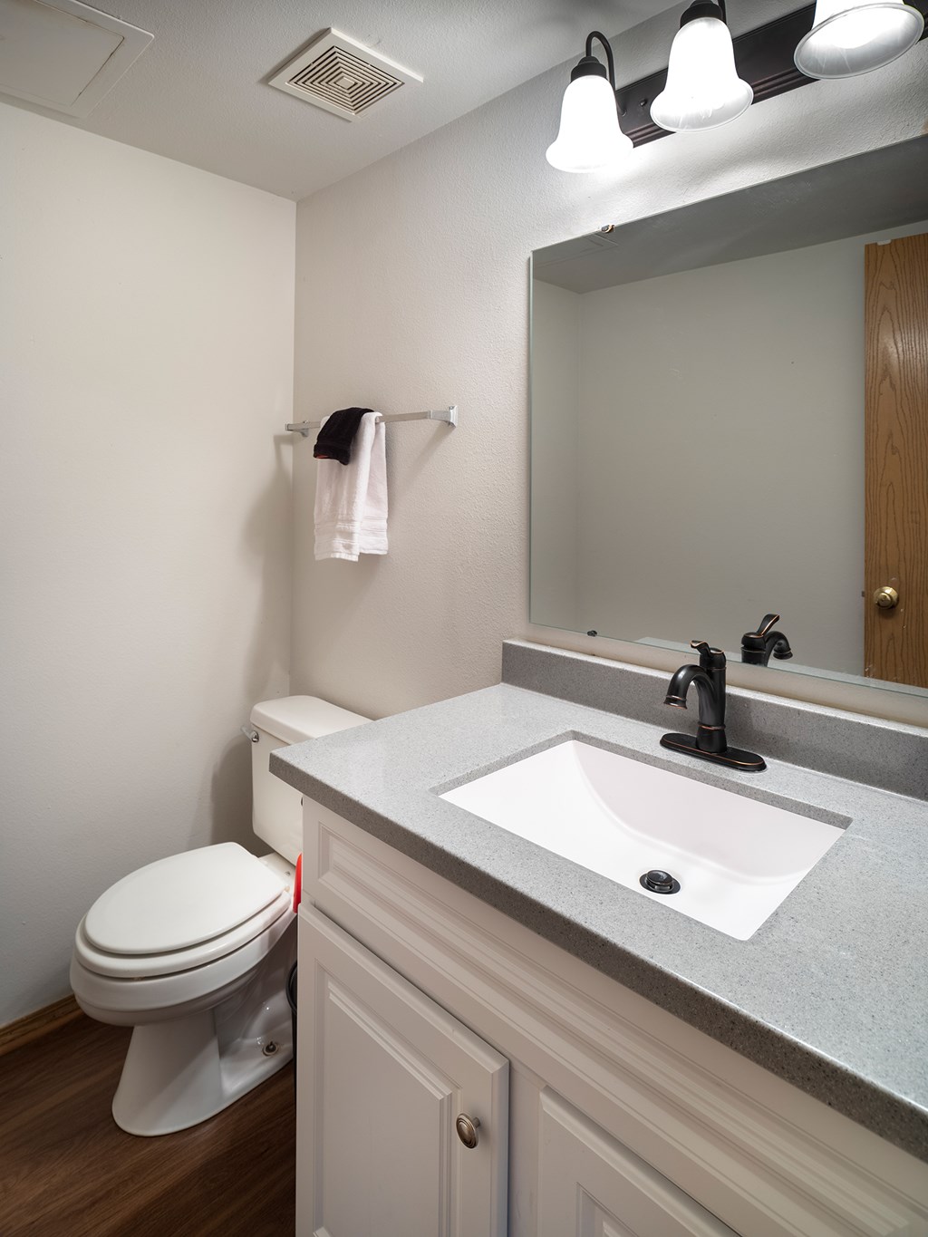A white toilet sits next to a sink in a bathroom.