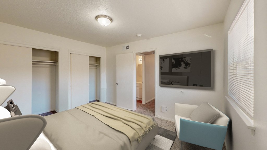 a bedroom with a bed and a tv on the wall