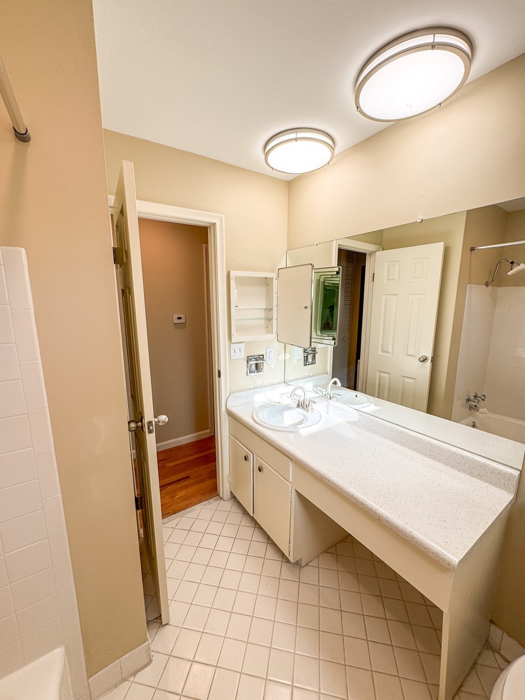 A bathroom with a sink, mirror, and toilet.