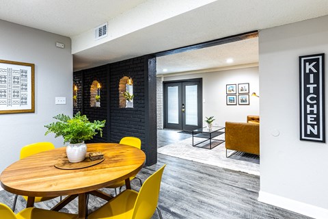 a dining room with a wooden table and yellow chairs