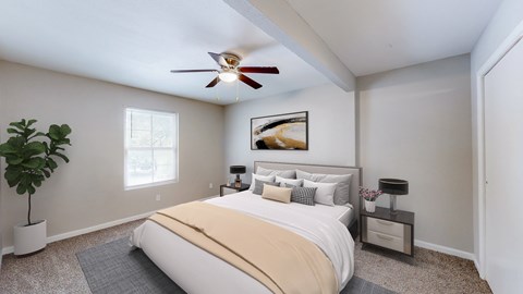 A bedroom with a large bed, a ceiling fan, and a painting on the wall.