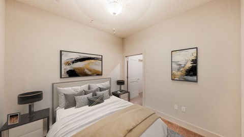 A bedroom with a bed, nightstand, and two pictures on the wall.