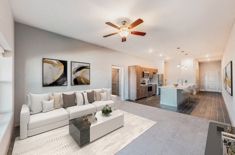 A modern living room with a white sofa and a coffee table.