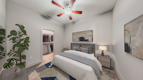A bedroom with a bed, a ceiling fan, and a painting on the wall.